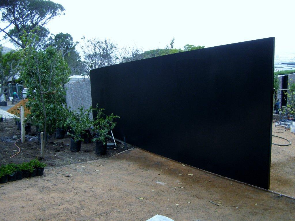 Curved galvanized steel gate painted black by Sterianos